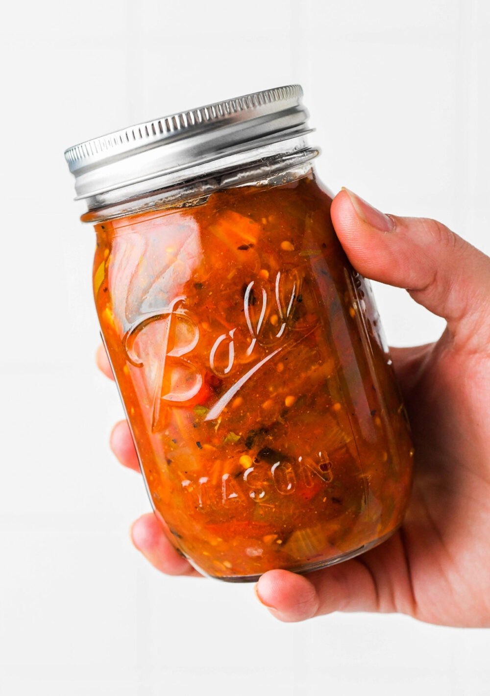 holding a jar of the best canned salsa