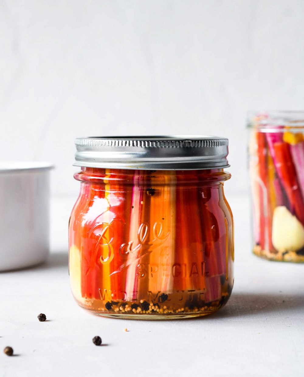 Spicy Pickled Chard Stems in a glass jar, with steel lid