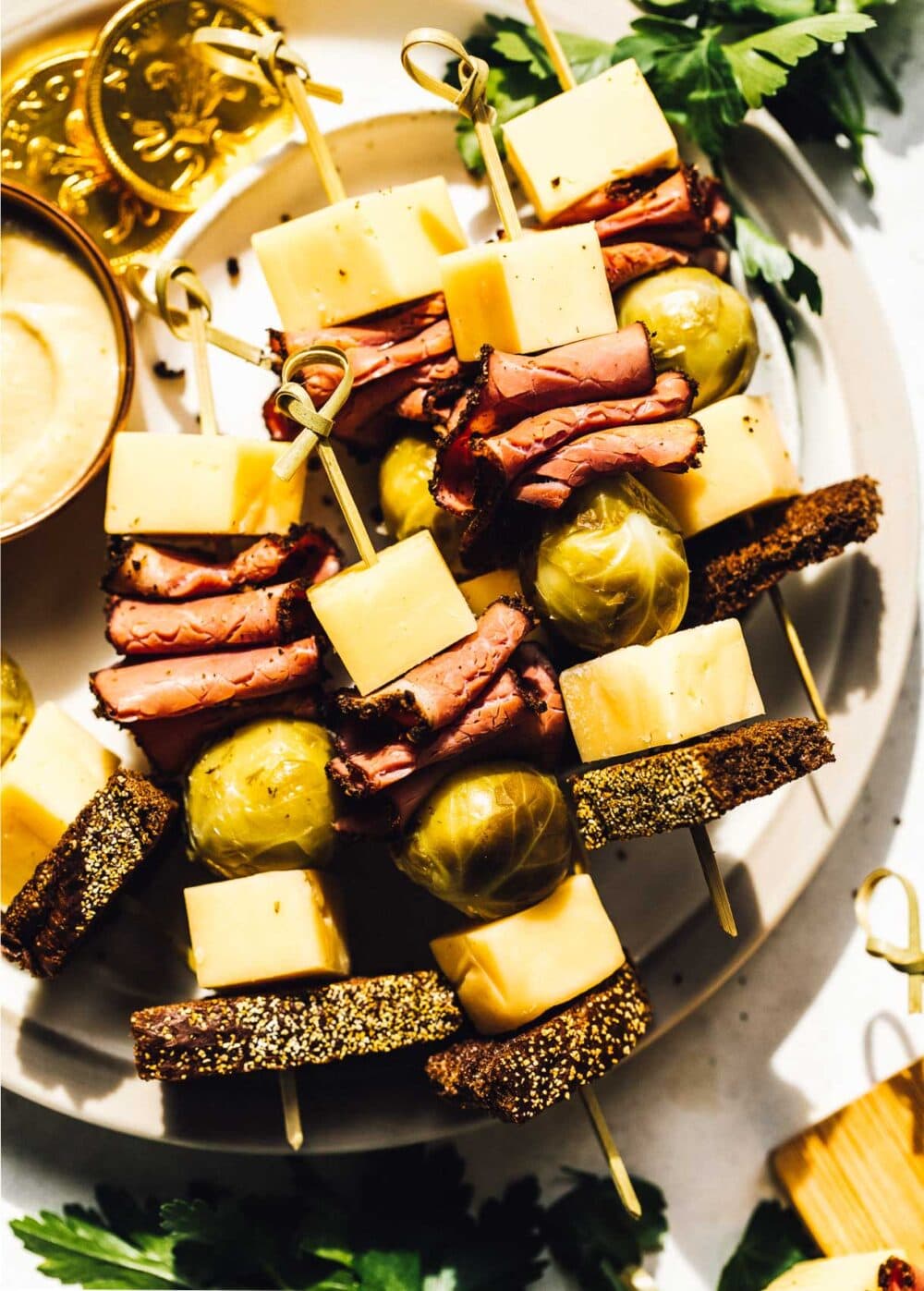 pickled brussels sprouts, cheese, pastrami and rye bread on skewers