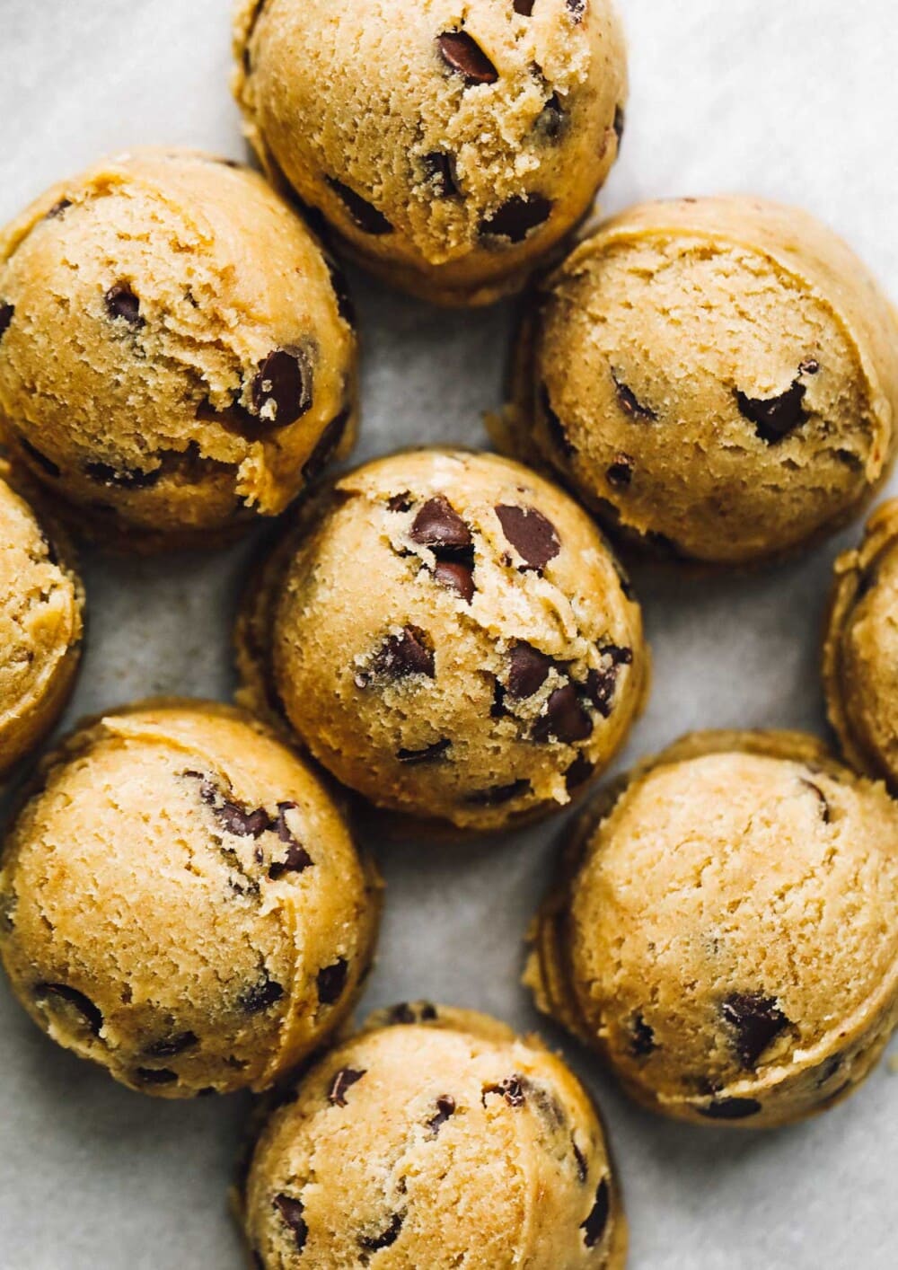 gluten-free chocolate chip cookie dough balls on parchment paper