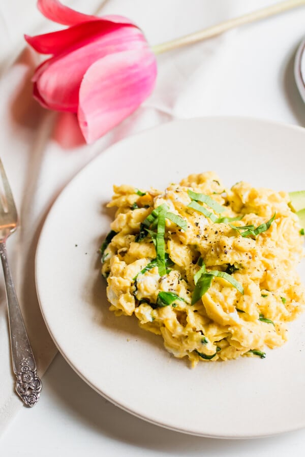 scrambled eggs with ramps on white plate