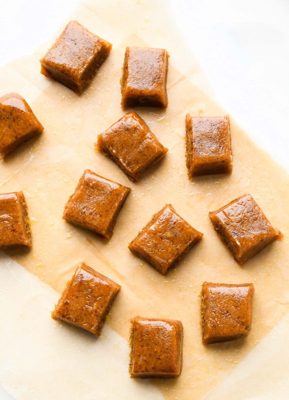 date caramels on parchment paper