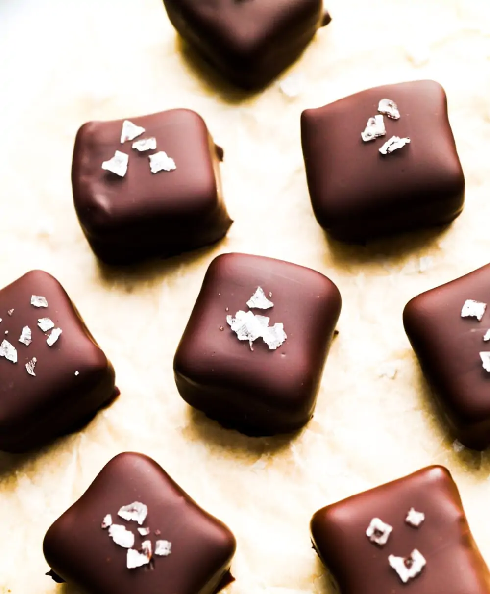 date caramels with flaky sea salt on parchment paper