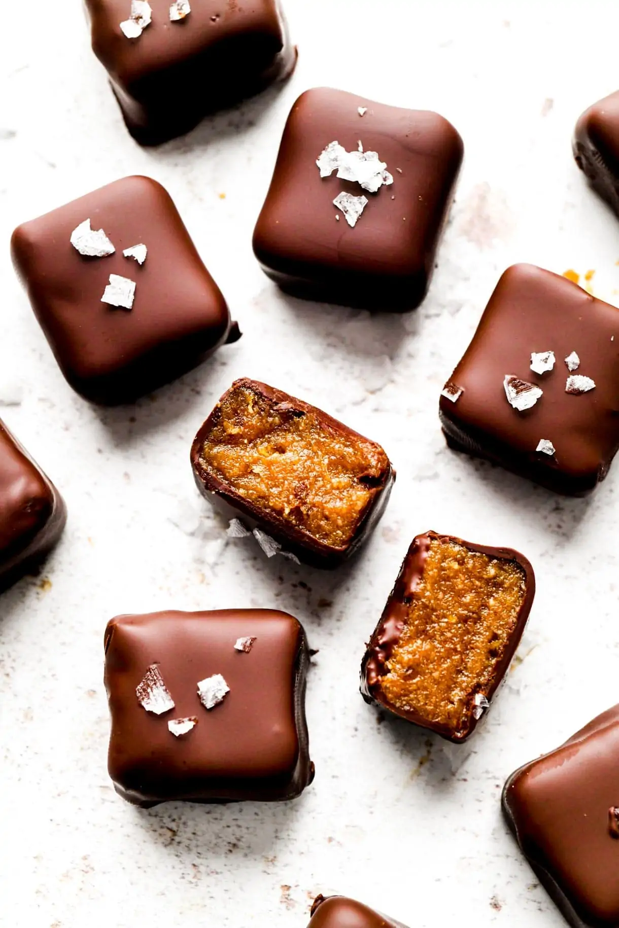 chocolate date caramels on a white surface