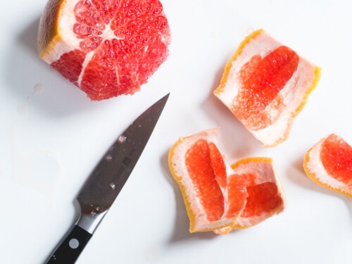 peels being cut off a grapefruit