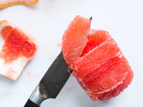 pairing knife cutting a grapefruit into segments