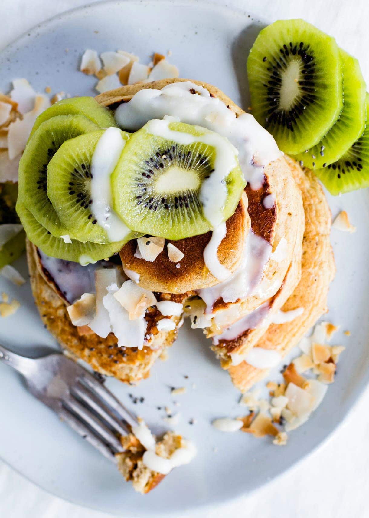 Fluffy Gluten-Free Pancakes with Coconut Butter Drizzle & Kiwis.