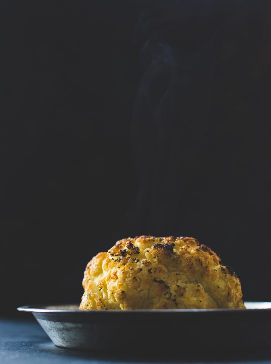 Incredible Whole Roasted Cauliflower Recipe with Cheese Sauce