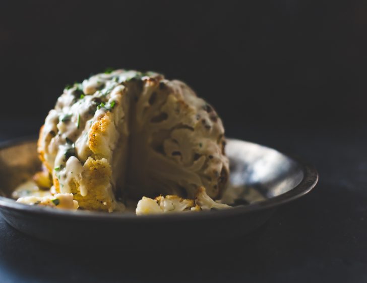 Incredible Whole Roasted Cauliflower Recipe with Cheese Sauce