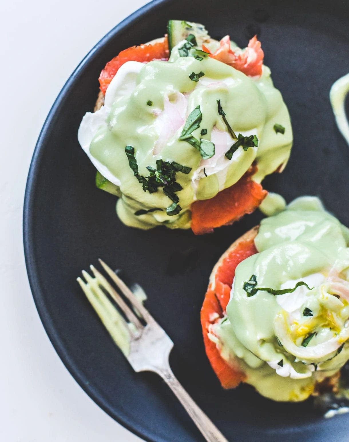 Smoked Salmon Eggs Benedict with Avocado Sauce, with cucumbers and pickled onions