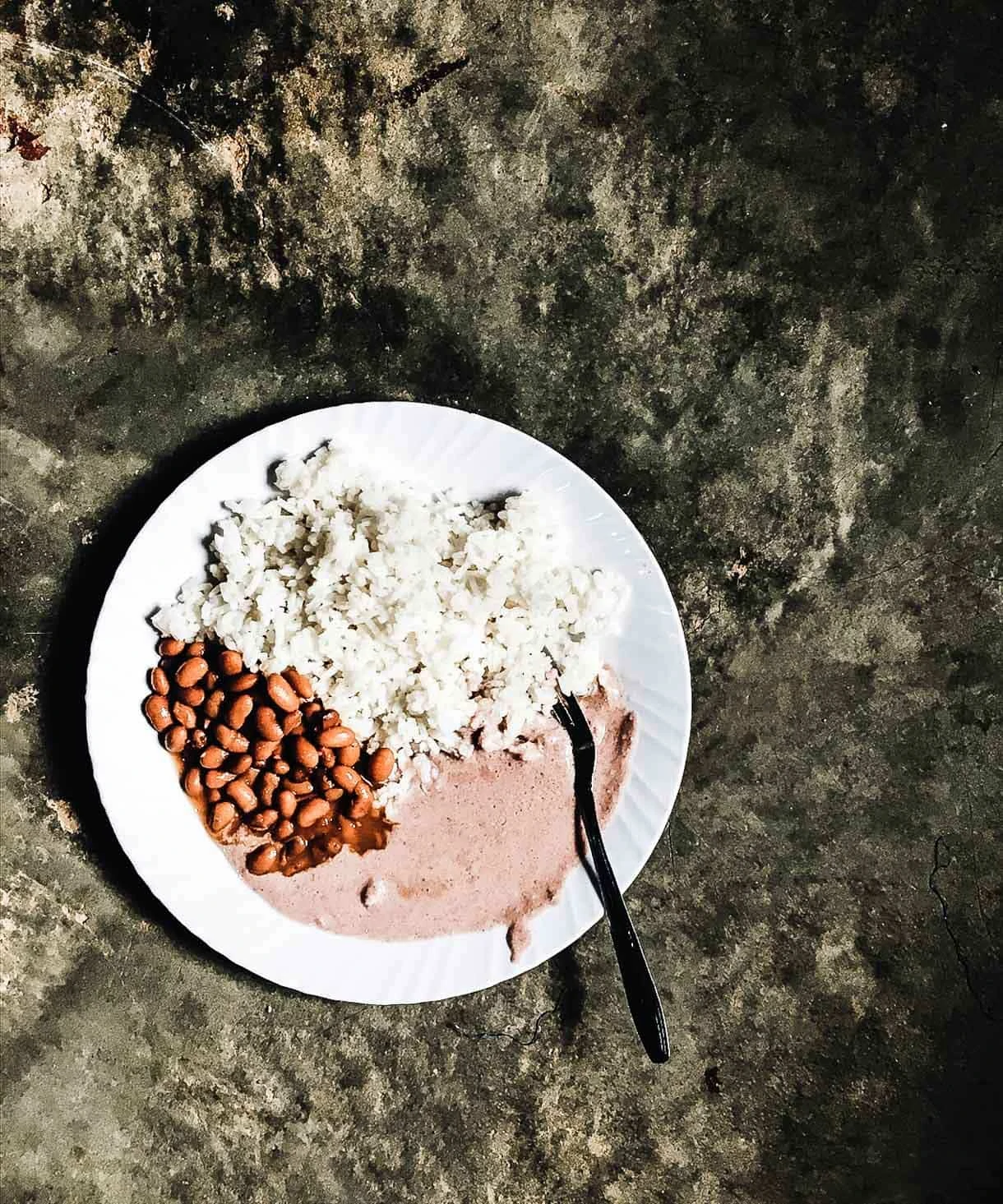 Nakivale - Rice and Beans lunch, with g. nuts sauce {ground peanut sauce}