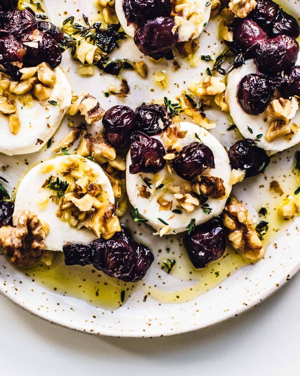 marinated goat cheese served with roasted grapes and walnuts