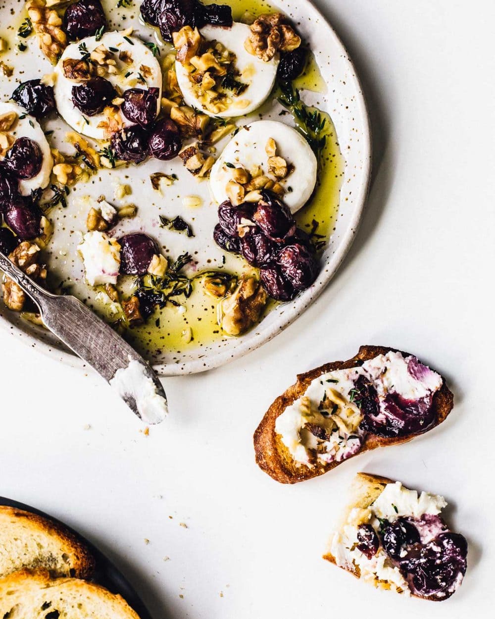 a platter with marinated goat cheese and crostini