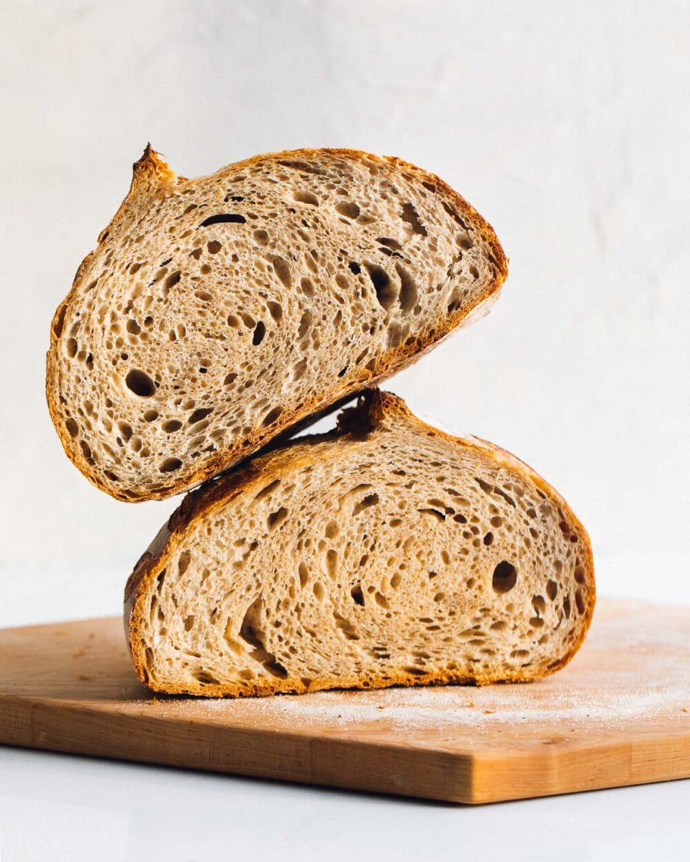 whole wheat sourdough bread, sliced in half and stacked on top of each other