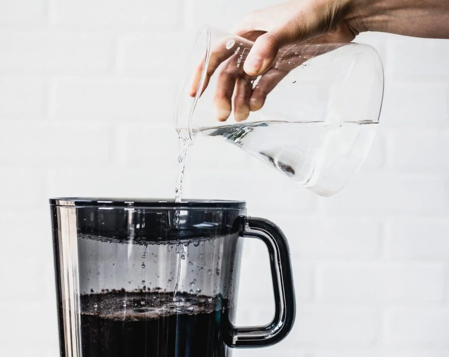 pouring water into OXO cold brew machine