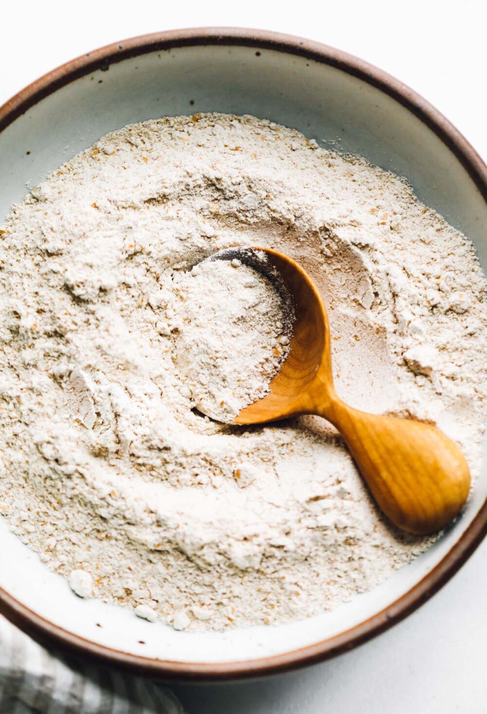 red fife flour in a bowl with a wooden spoon