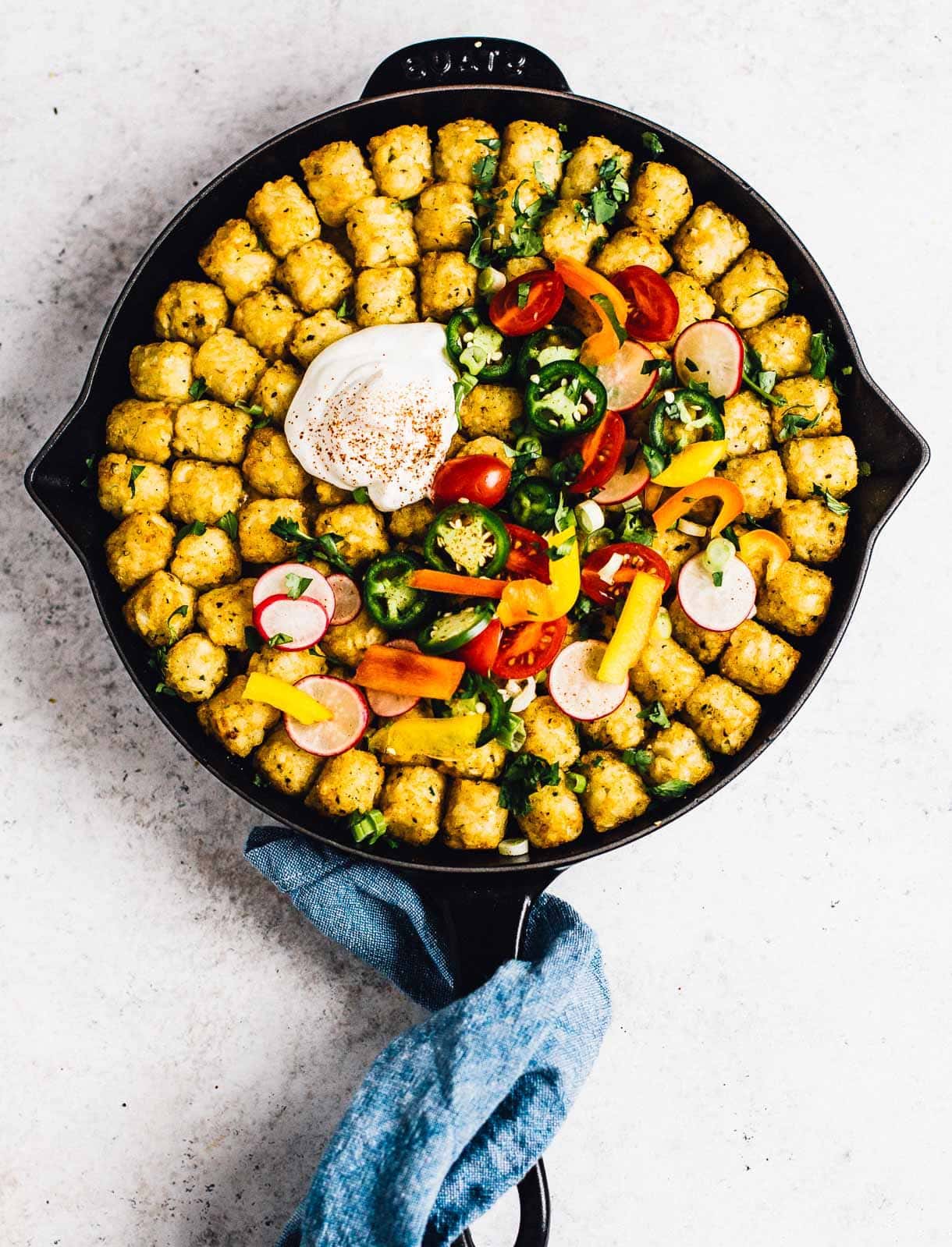 tater tot casserole in a cast iron skillet, overhead photograph