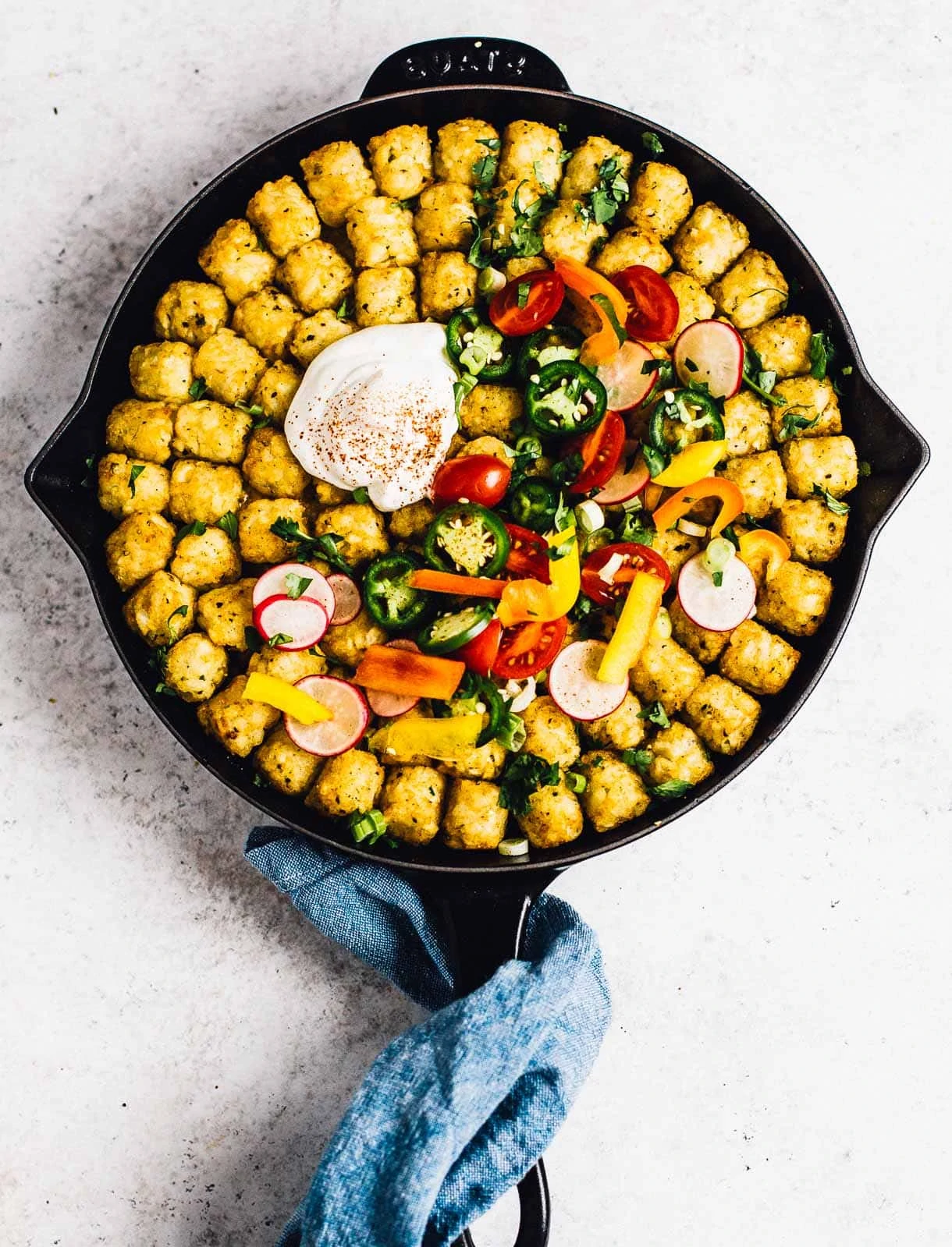 tater tot casserole in a cast iron skillet, overhead photograph