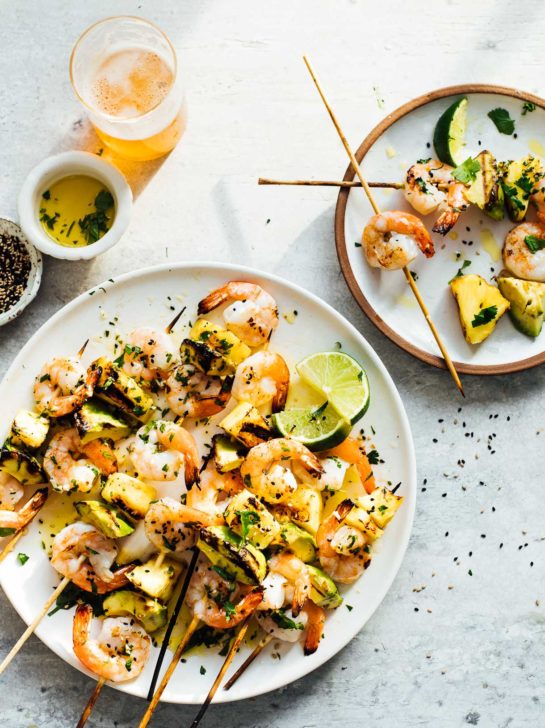 grilled shrimp skewer with pineapple and avocado served with beer