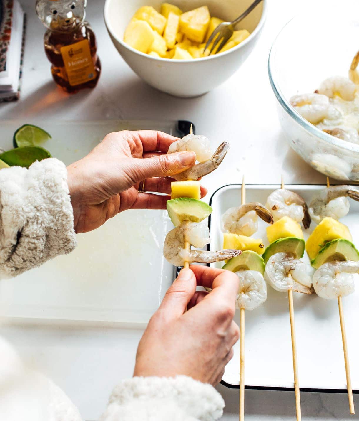 threaded shrimp, avocado, and pineapple onto wooden skewers