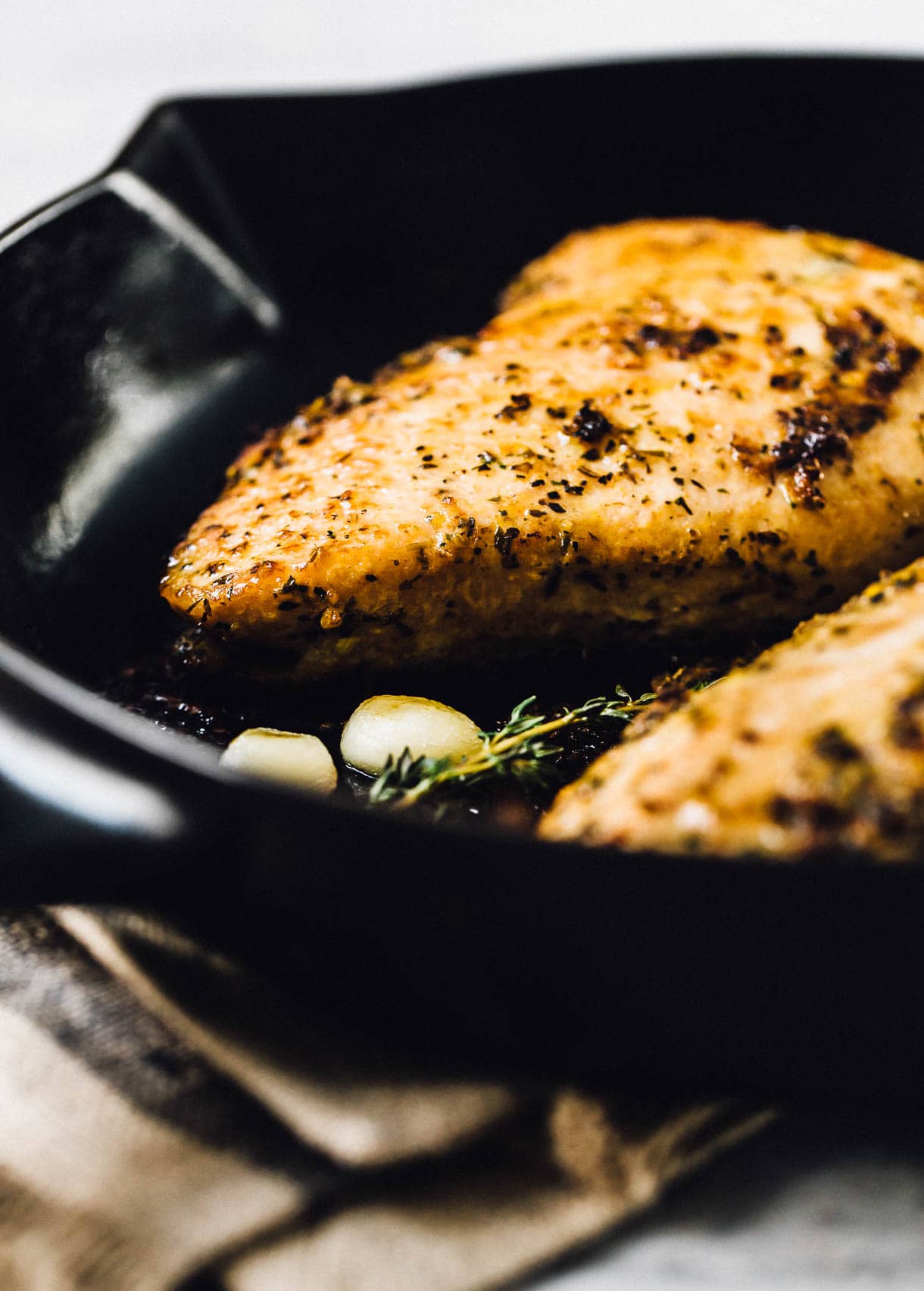 turkey tenderloin being cooked in a cast iron skillet