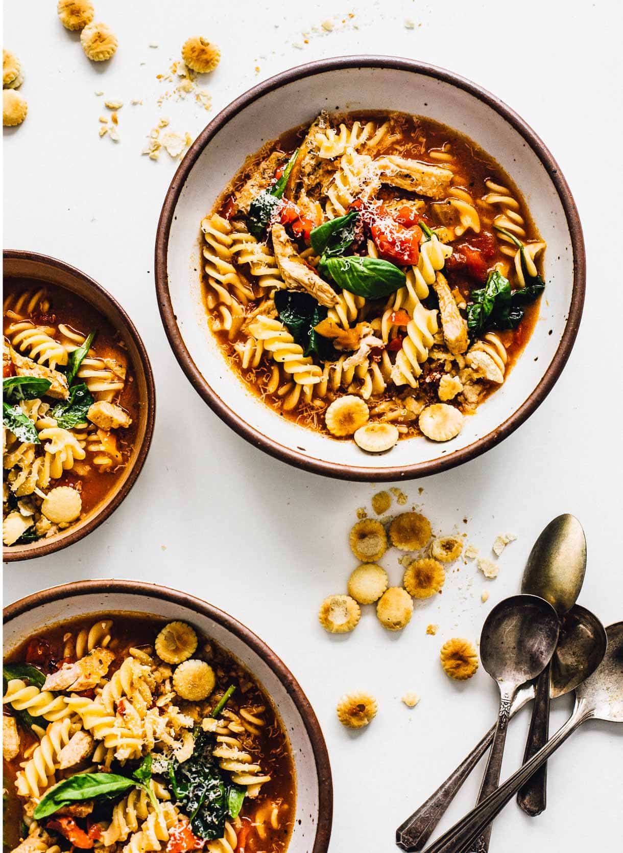 Turkey Tuscan Pasta Soup in three bowls with oyster crackers