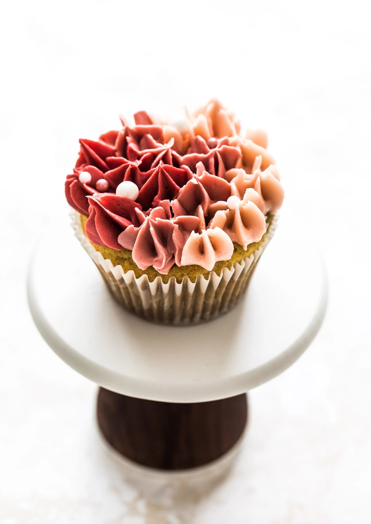 Beautiful rose colored cupcakes on a cupcake stand