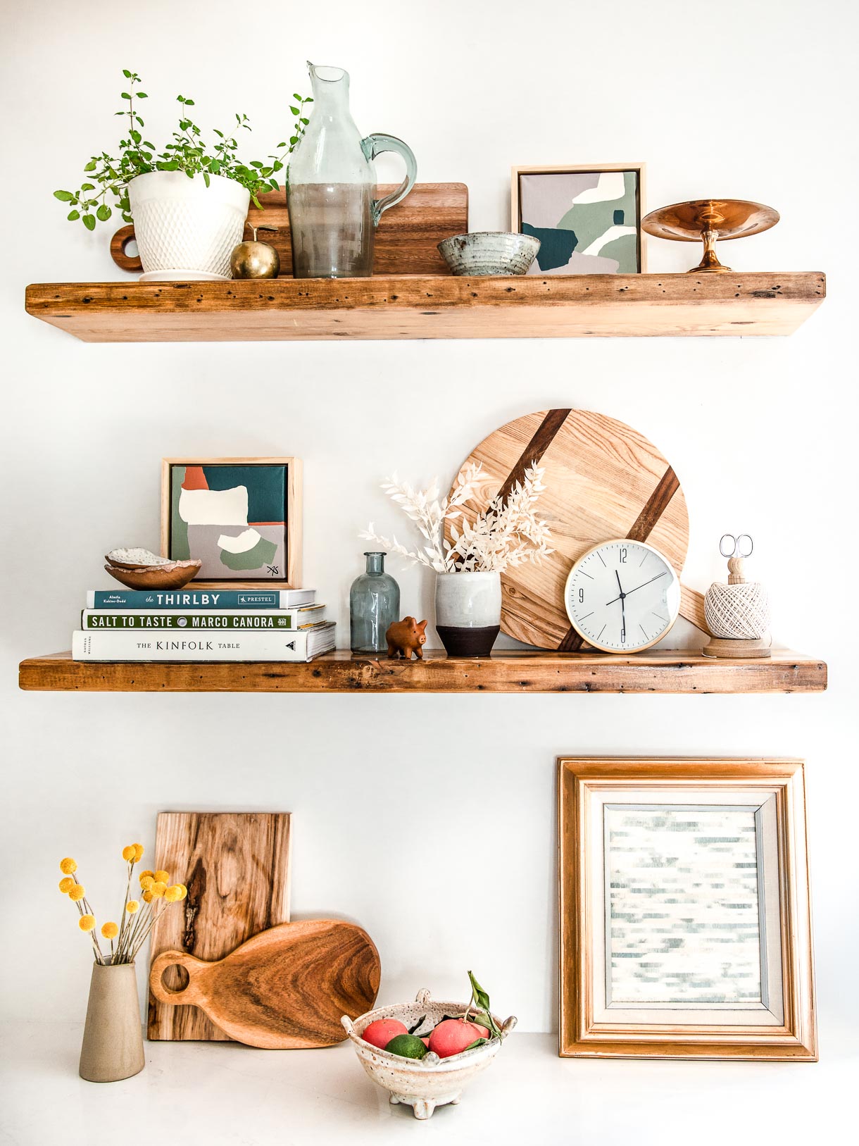 reclaimed wood shelving on white walls with styling of items