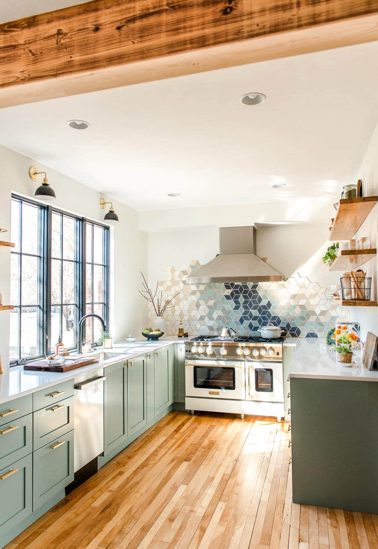white u-shaped kitchen with modern tile backsplash and white blue star range