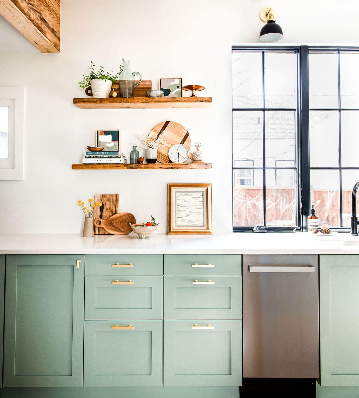 modern white kitchen with green cabinets