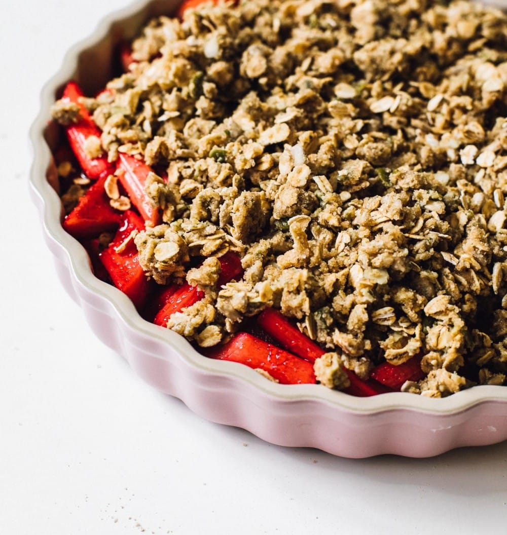 unbaked rhubarb crisp in pink pan