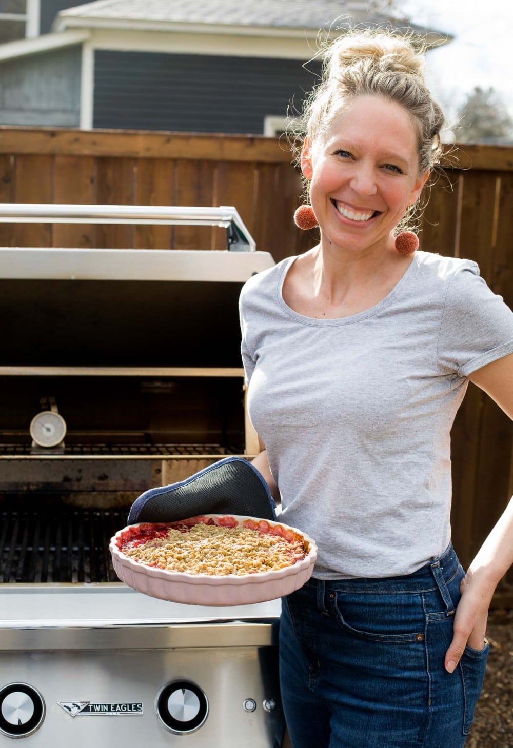 girl holding dessert in front of grill