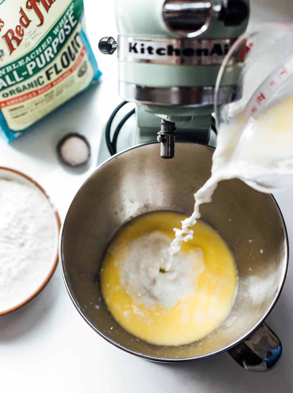 pouring milk into kitchenaid stand mixer