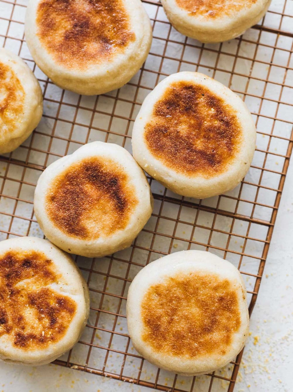 sourdough english  muffins on cooling rack