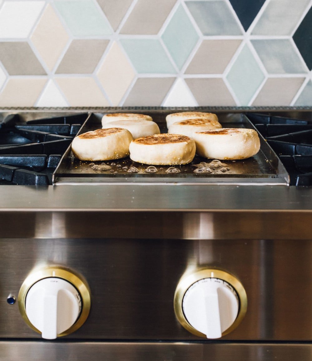 english muffins cooking on griddle