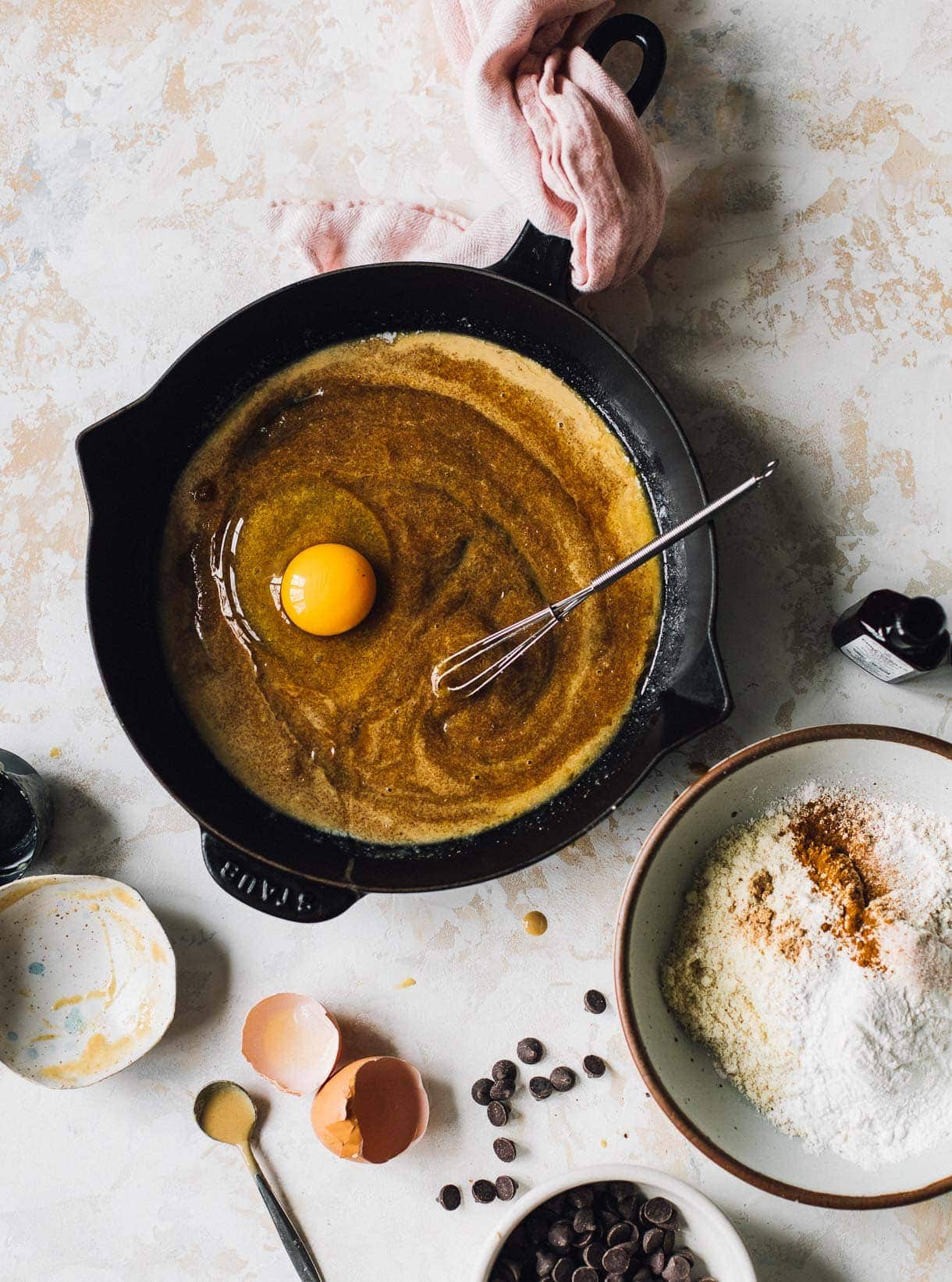 mixing a skillet cookie, egg in cast iron skillet