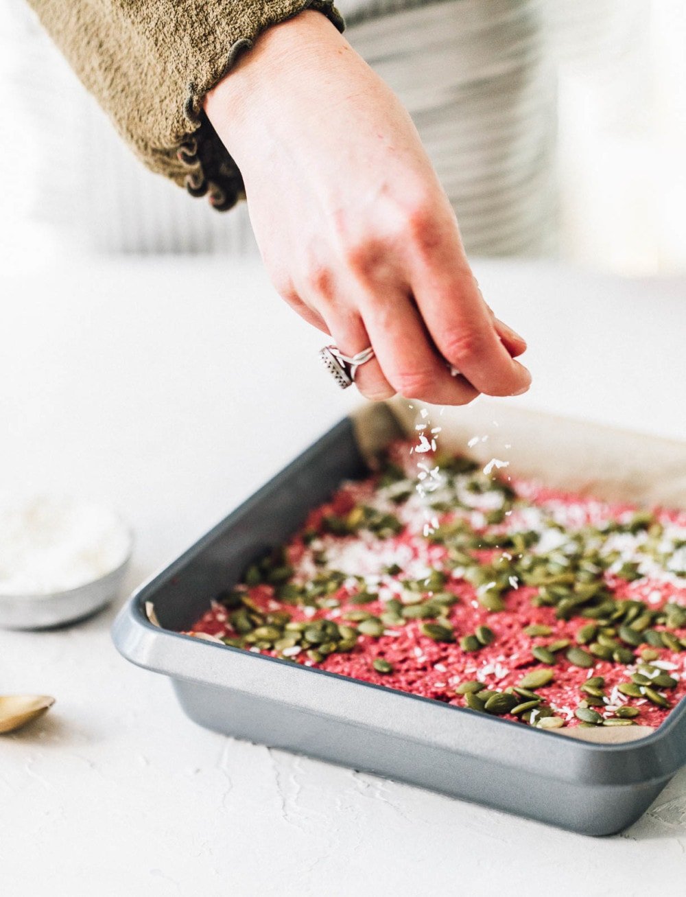 sprinkling coconut on cherry bars