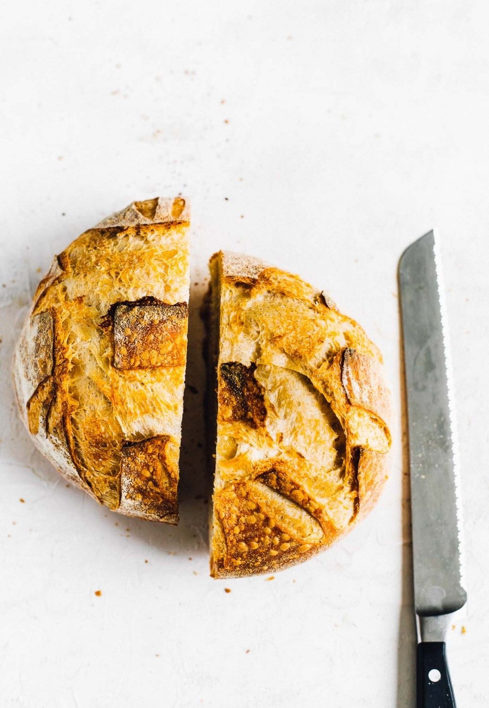 sourdough bread sliced in half with bread knife