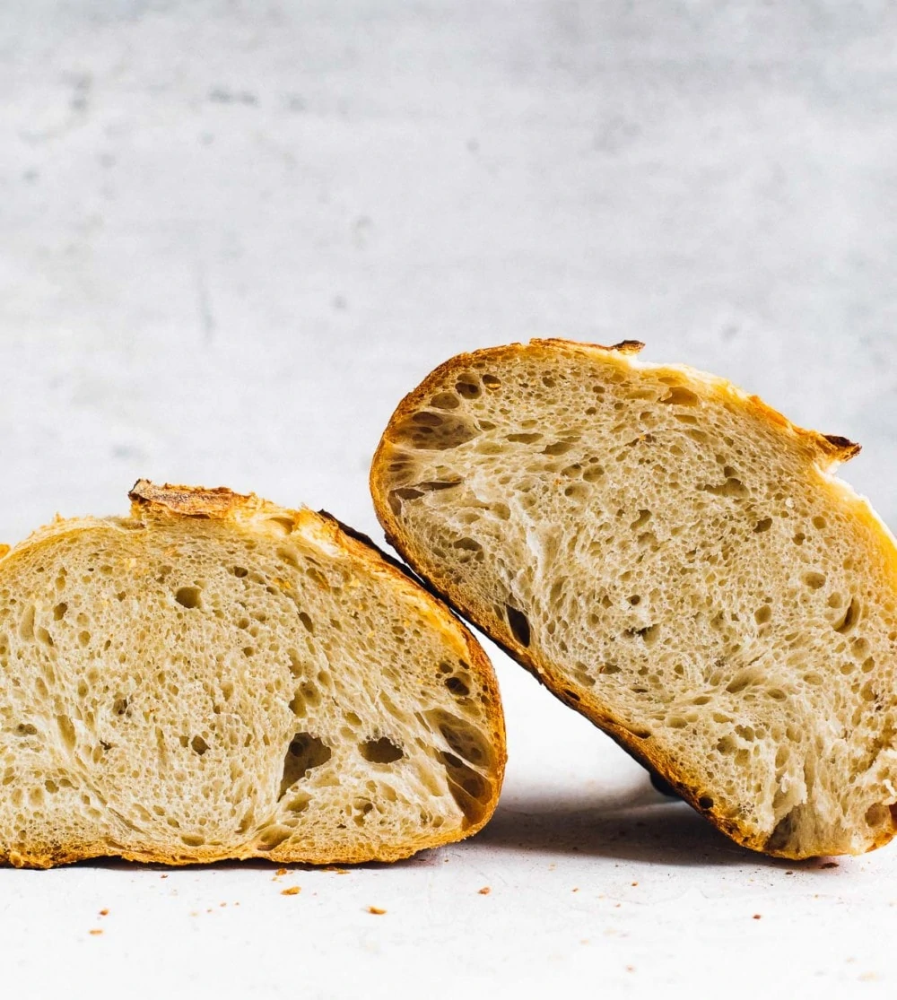 open crumb shot of sourdough bread loaf, cut in half