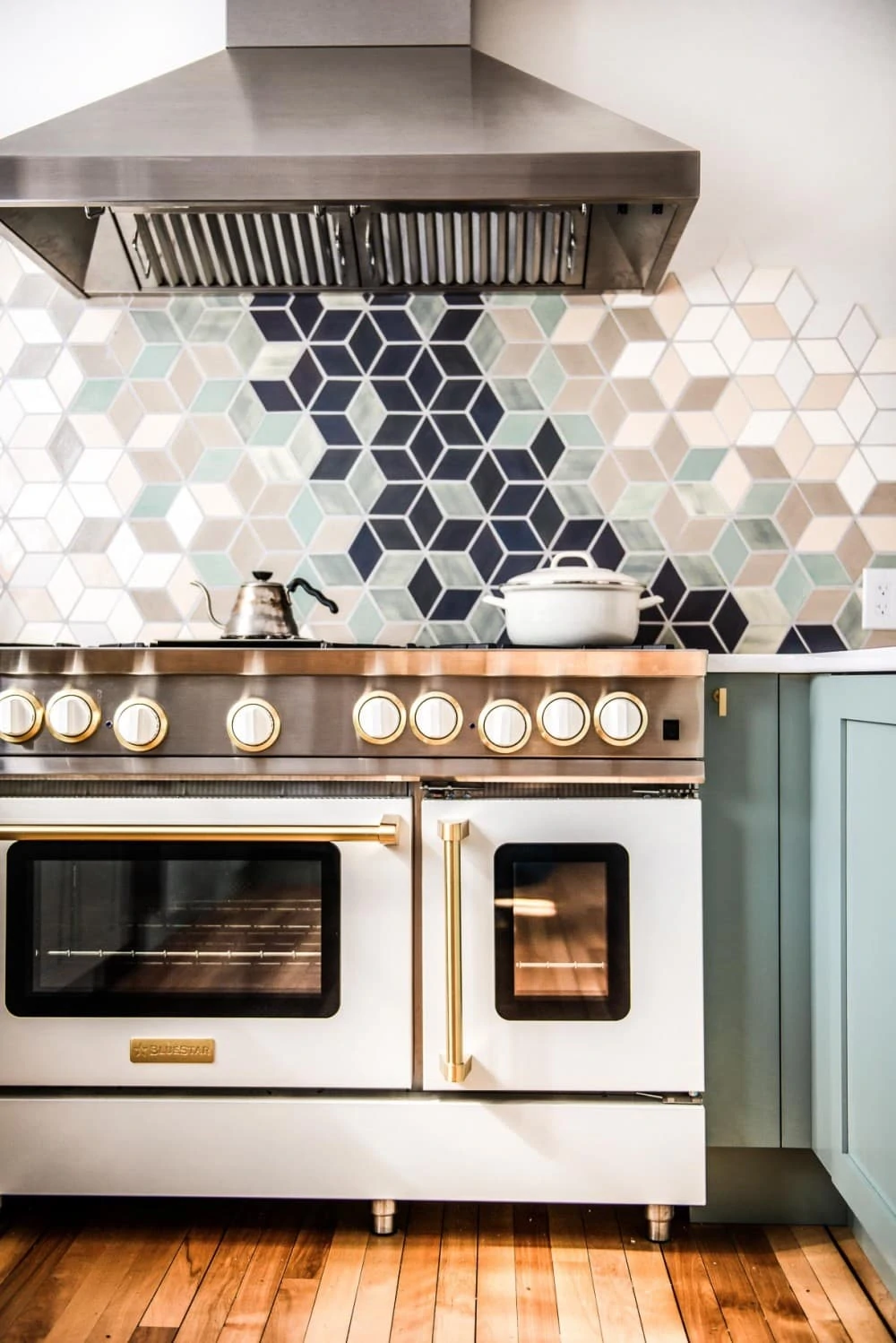 white blue star range with gold trim in a white kitchen