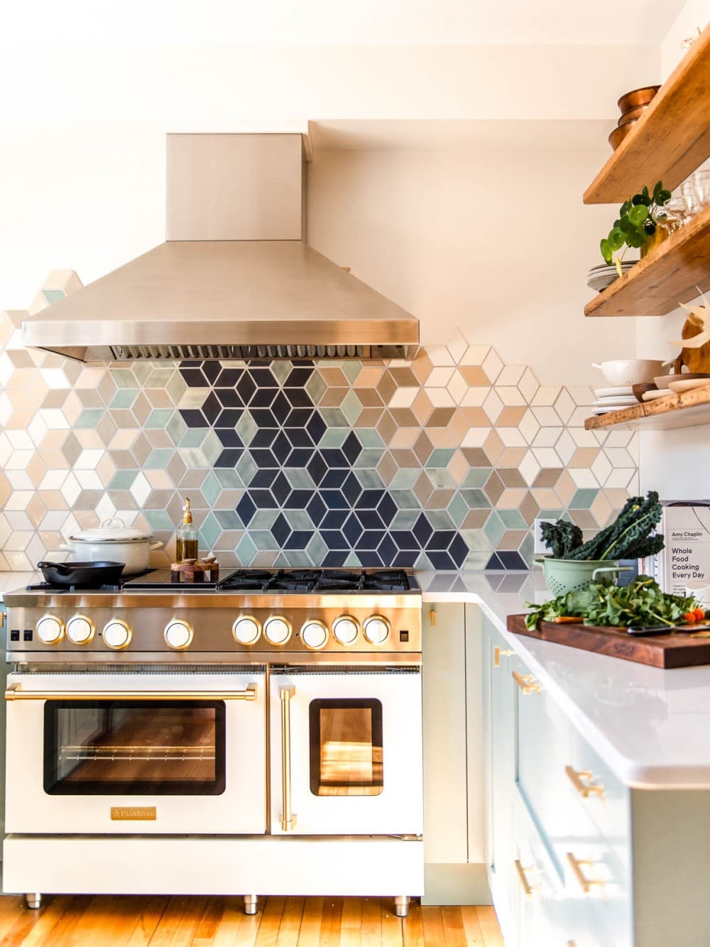 modern white kitchen with white range and stainless steel hood