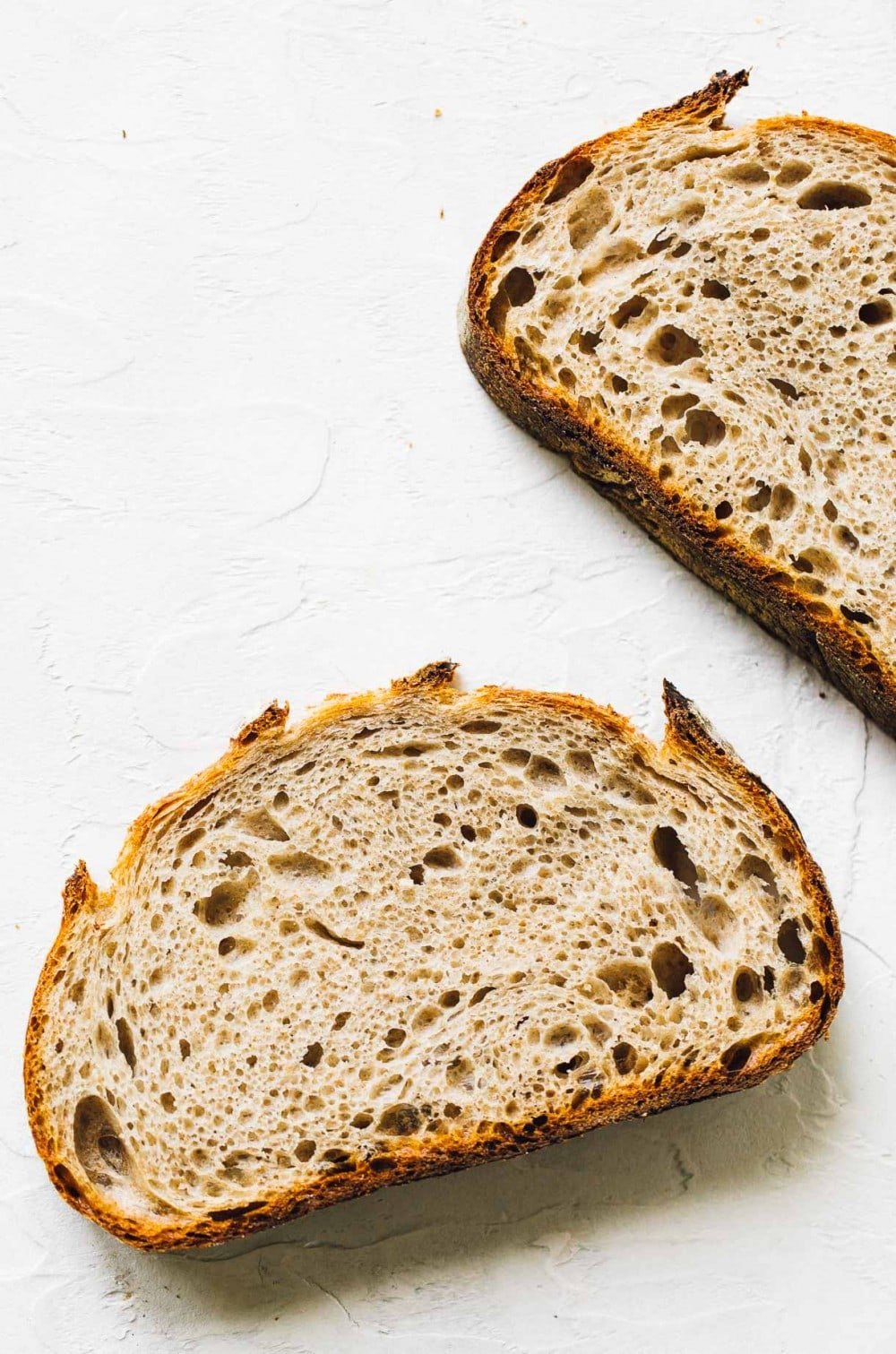 2 slices of rye sourdough bread, laying down, overhead photo