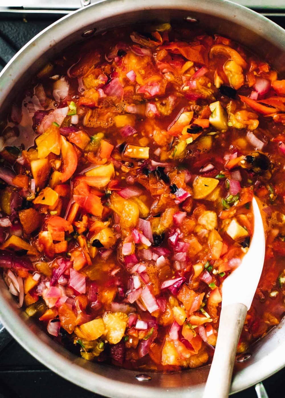 tomato peach salsa in a saucepan on stove