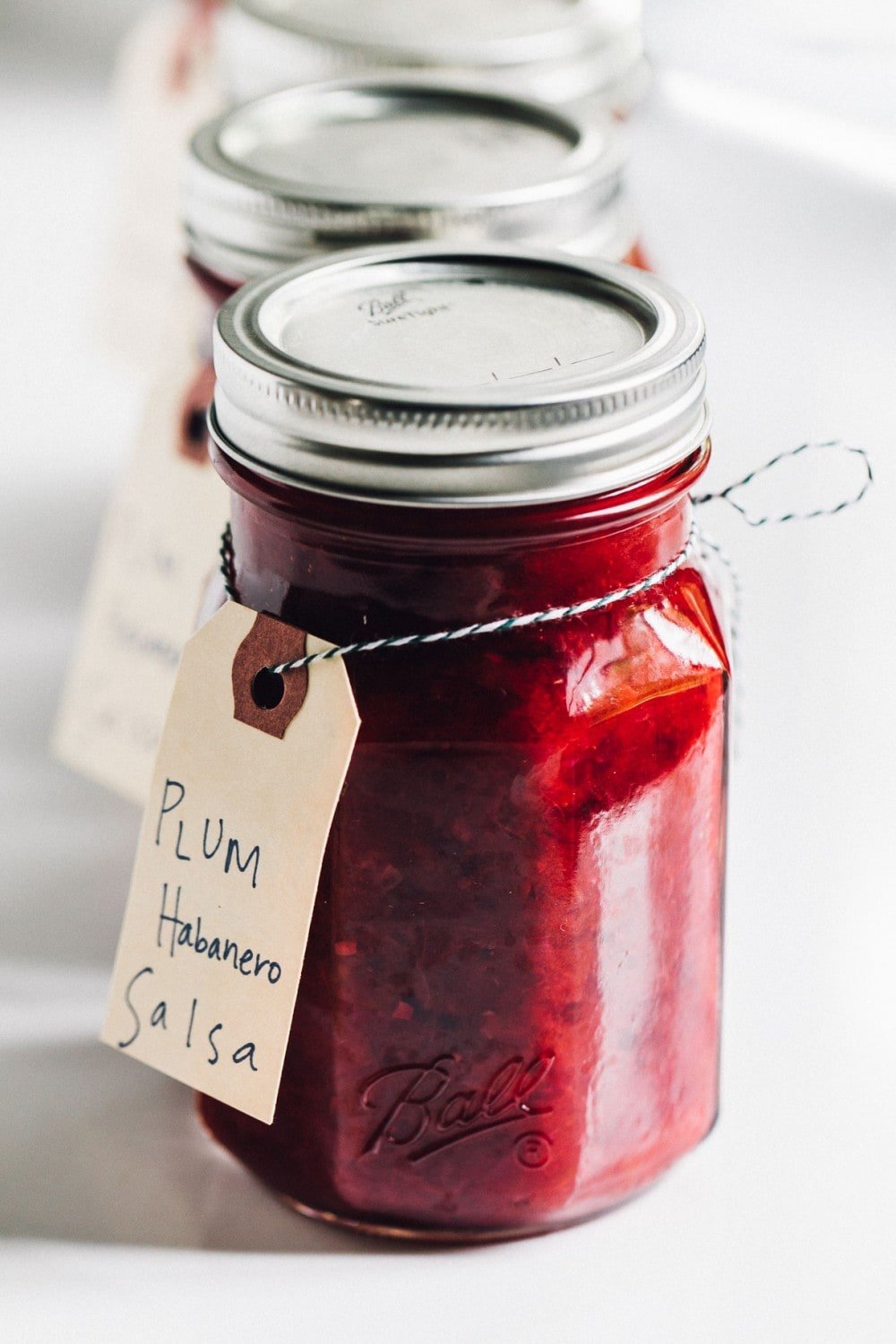 plum habanero salsa in glass ball jars, lined up