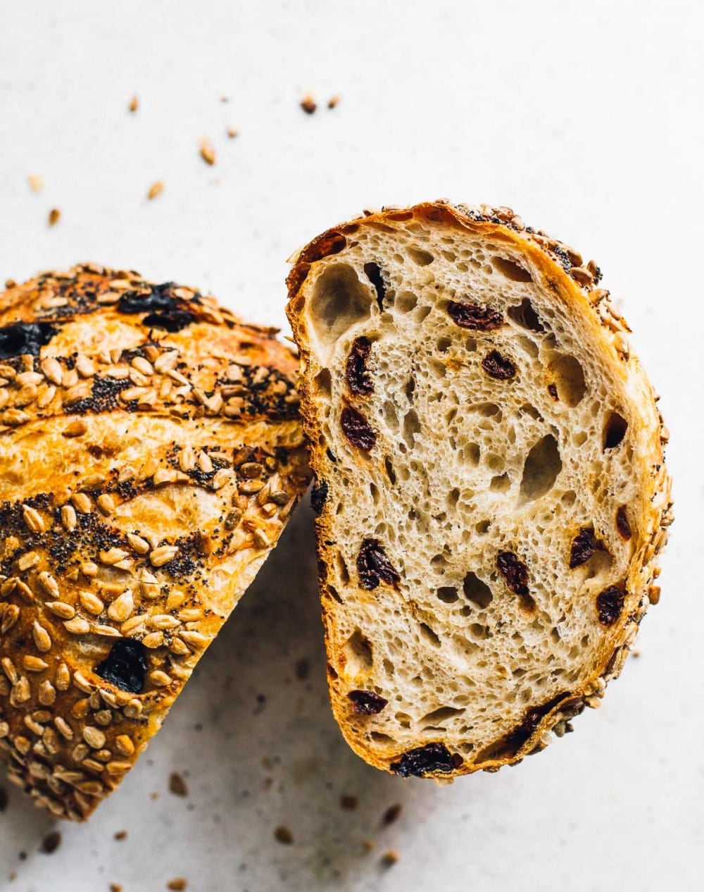 overhead photo of tart cherry sourdough bread, cut in half to show interior crumb