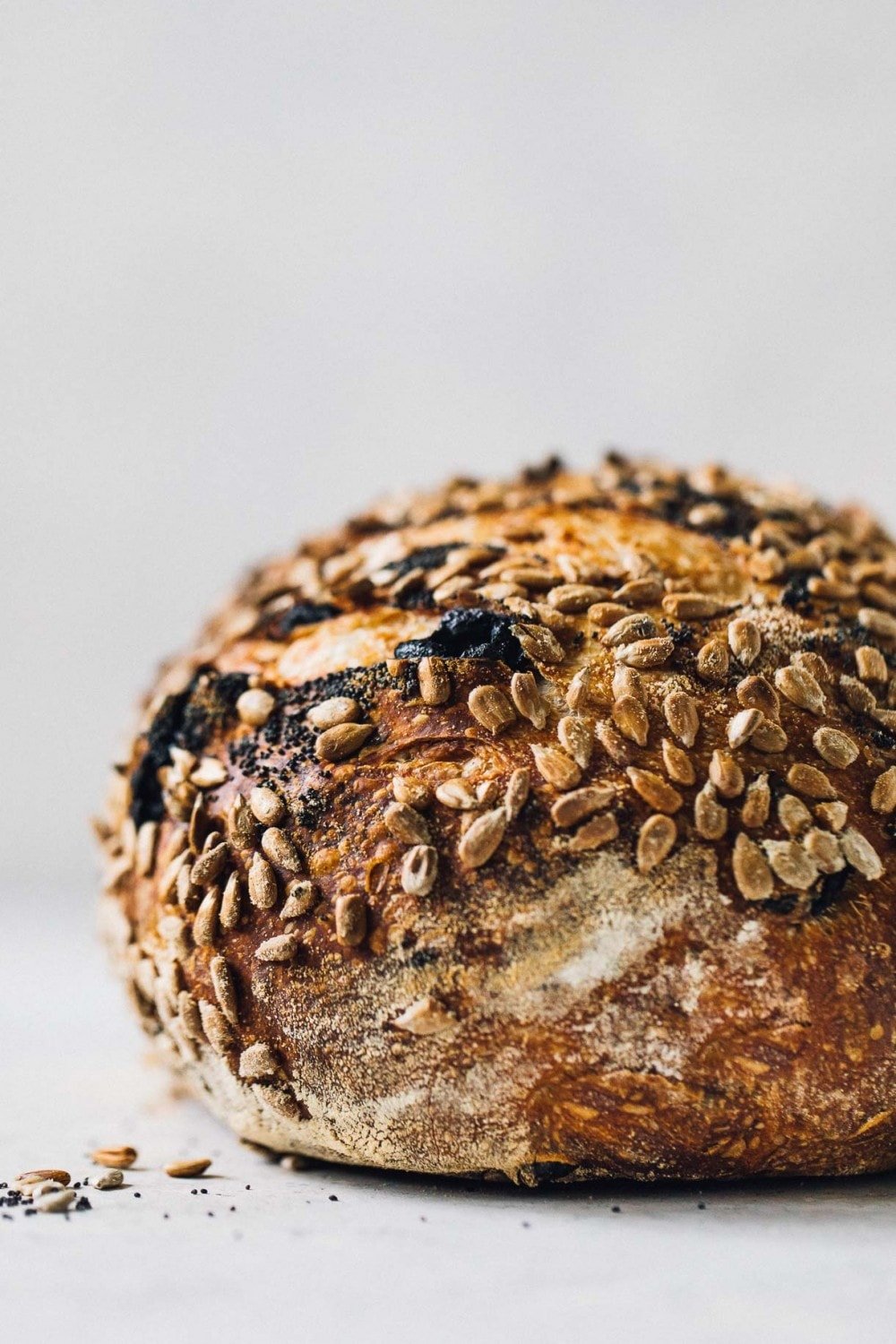 side view of a loaf of seeded sourdough bread