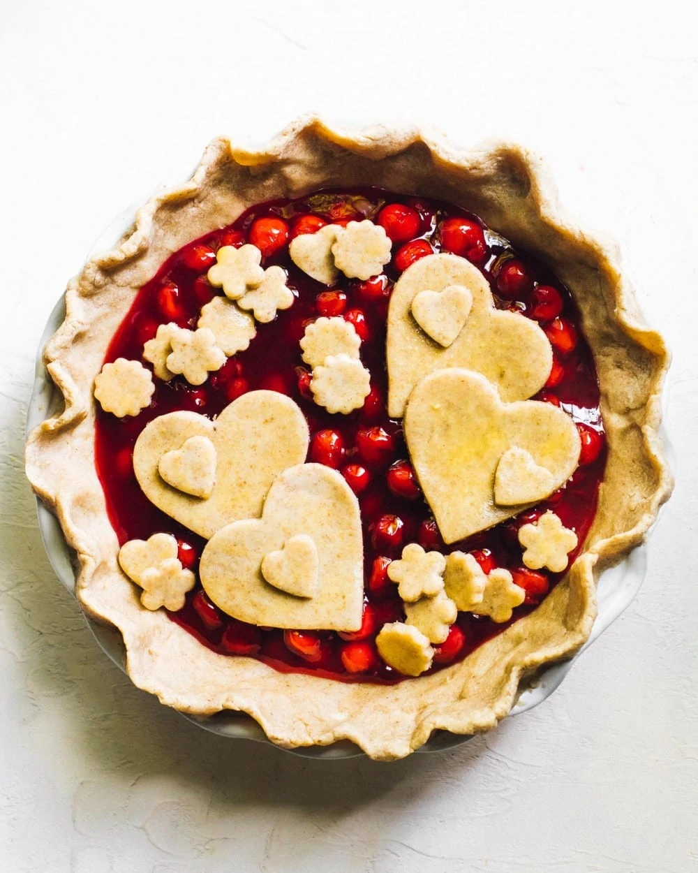 unbaked gluten free cherry pie with hearts on top for the pie crust