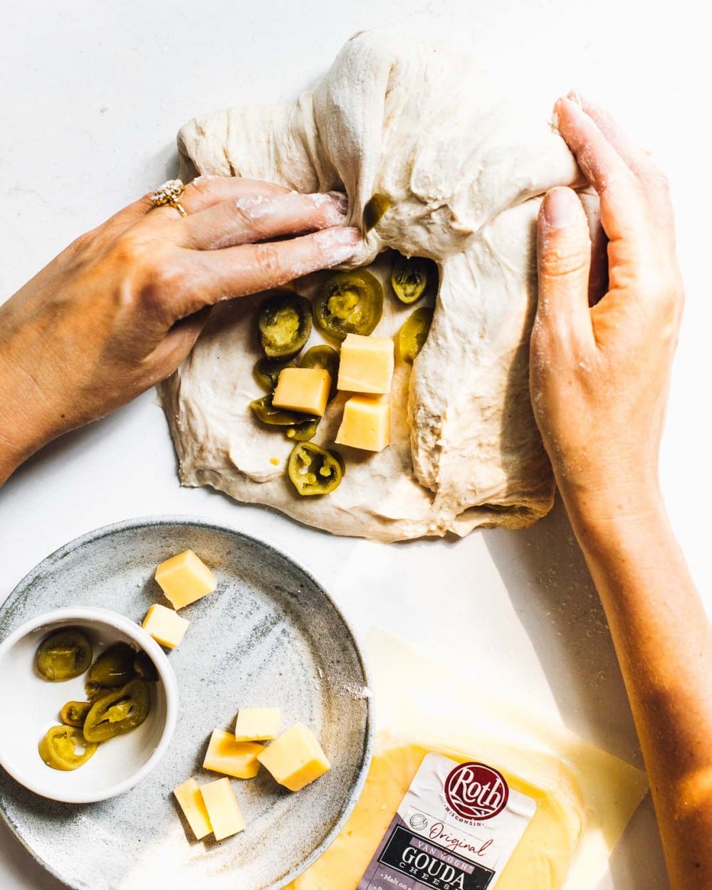 folding cheese and jalapenos into bread dough