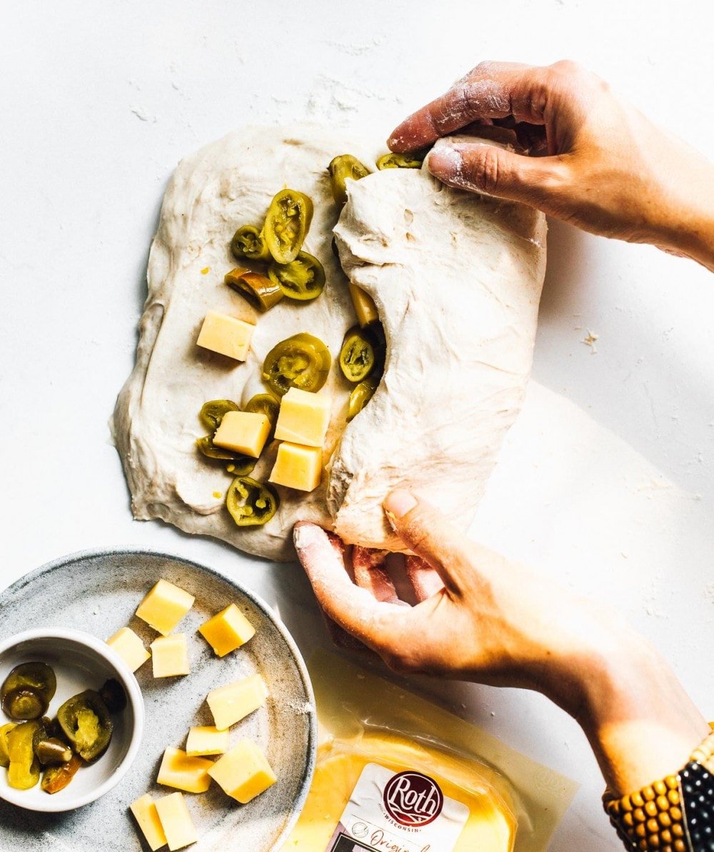 folding cheese and jalapenos into bread dough