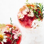 flower decorated frozen wine cocktails, two glasses next to each